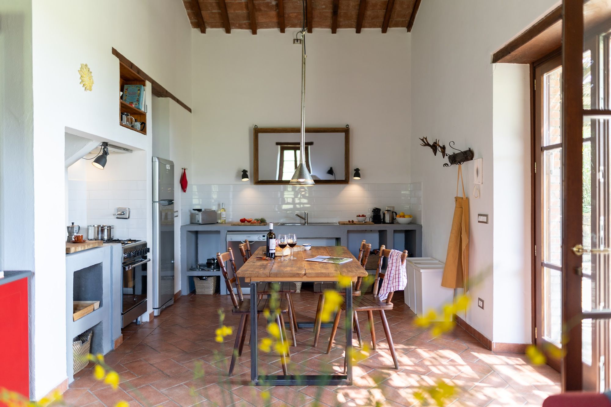 Kitchen and dining room at Casa Campori with doors open to the garden