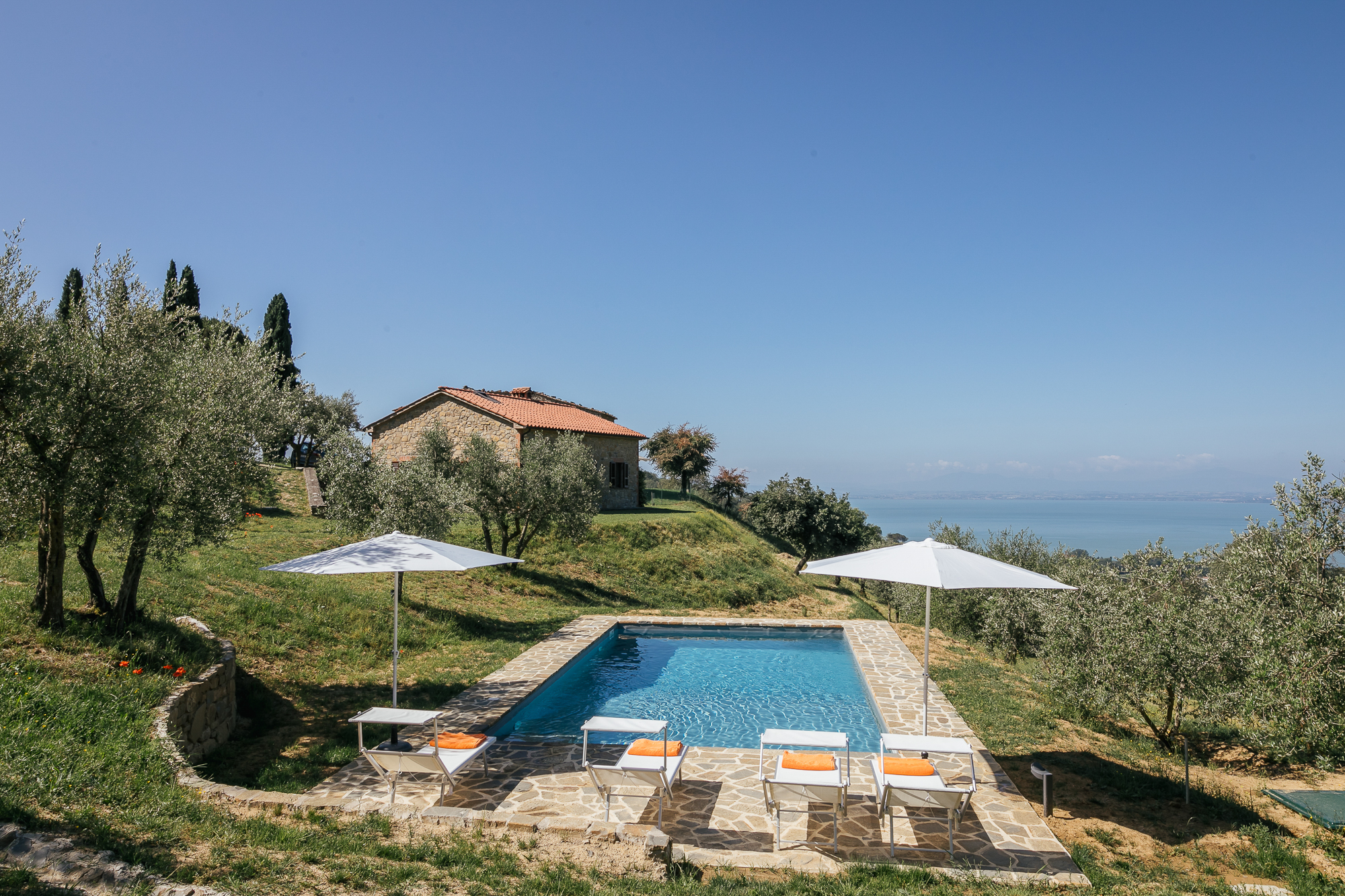 Casa Campori and its private pool among olive trees above Lake Trasimeno